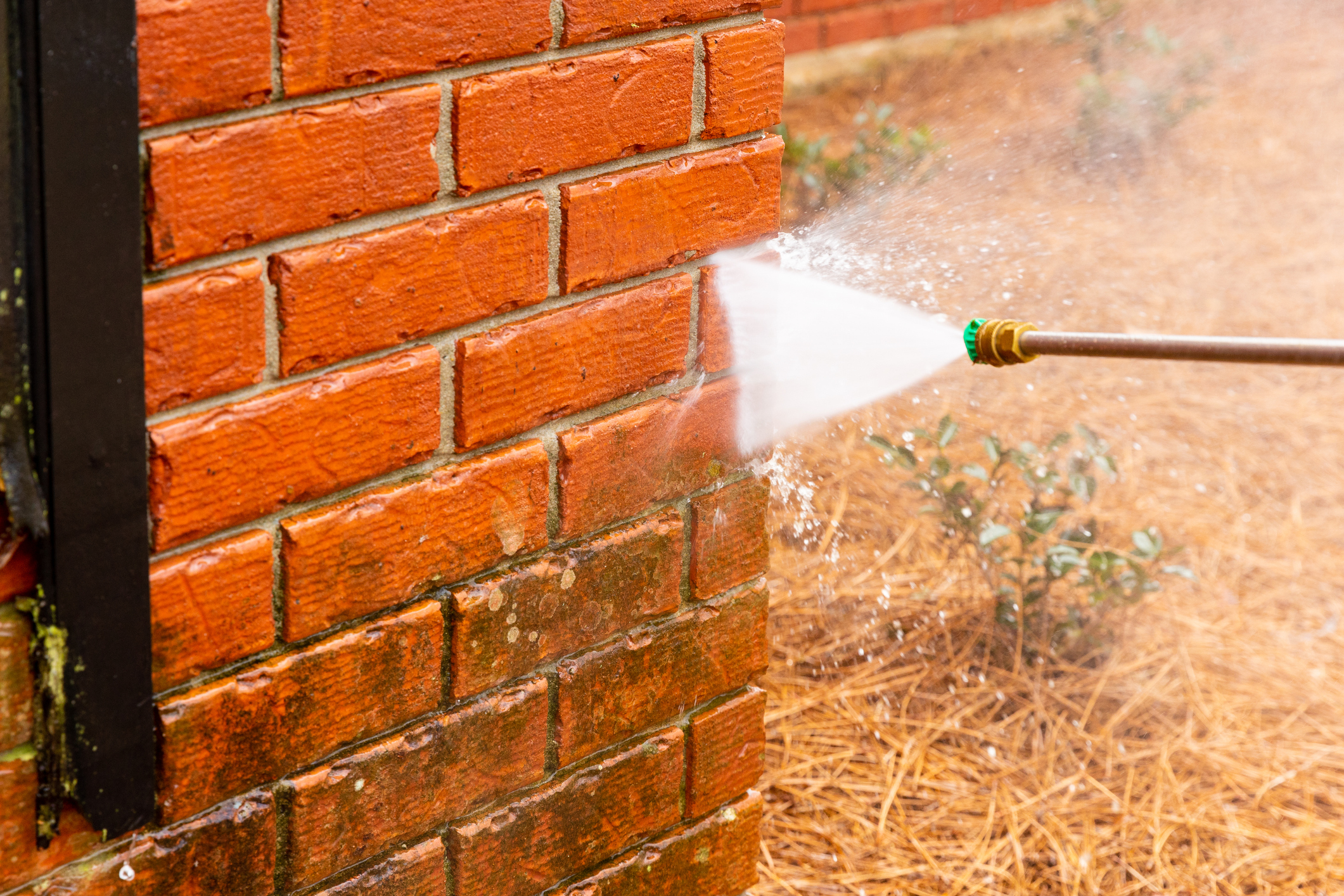 Power washing a brick wall near Bedford, Ohio